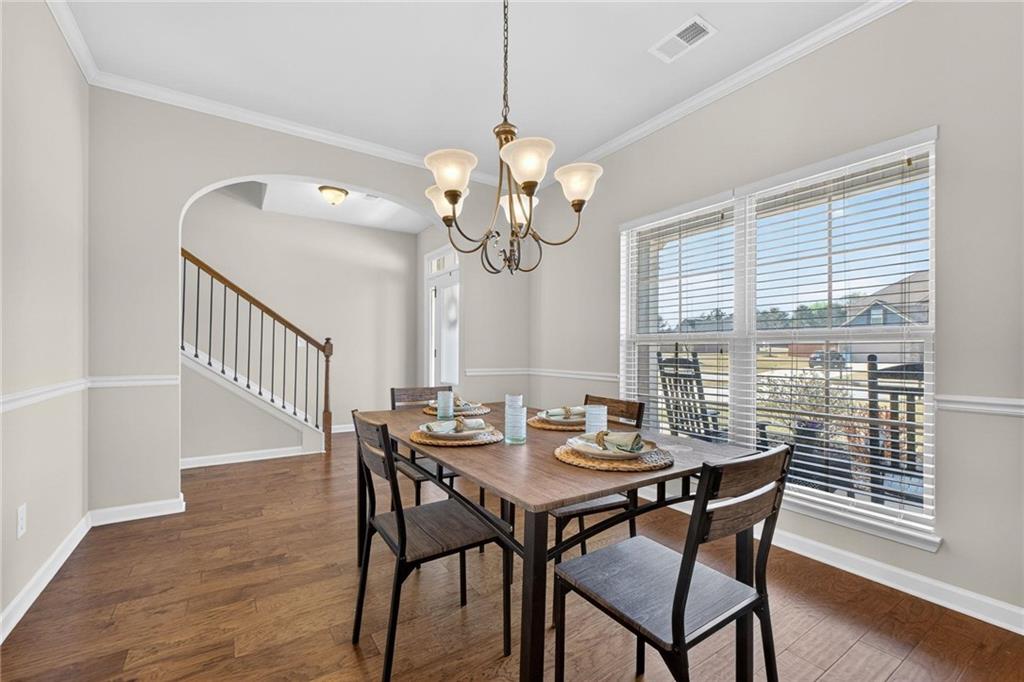 214 Millie Court Jackson, GA 30233 - Photo 12 of 61 a view of a dining room with furniture a chandelier and wooden floor