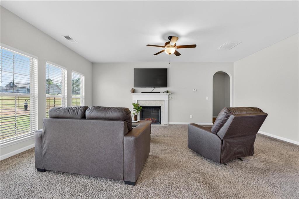 214 Millie Court Jackson, GA 30233 - Photo 14 of 61 a living room with furniture a fireplace and a flat screen tv