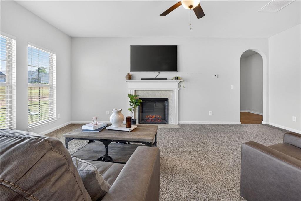 214 Millie Court Jackson, GA 30233 - Photo 16 of 61 a living room with furniture a fireplace and a flat screen tv