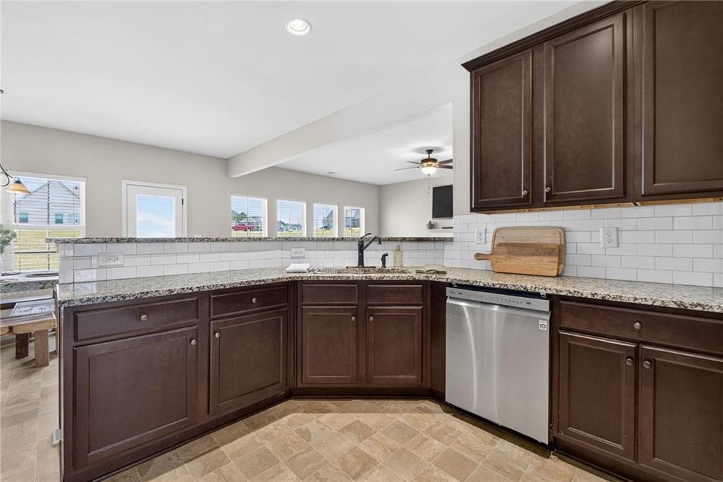 214 Millie Court Jackson, GA 30233 - Photo 20 of 61 a kitchen with granite countertop sink cabinets and stainless steel appliances