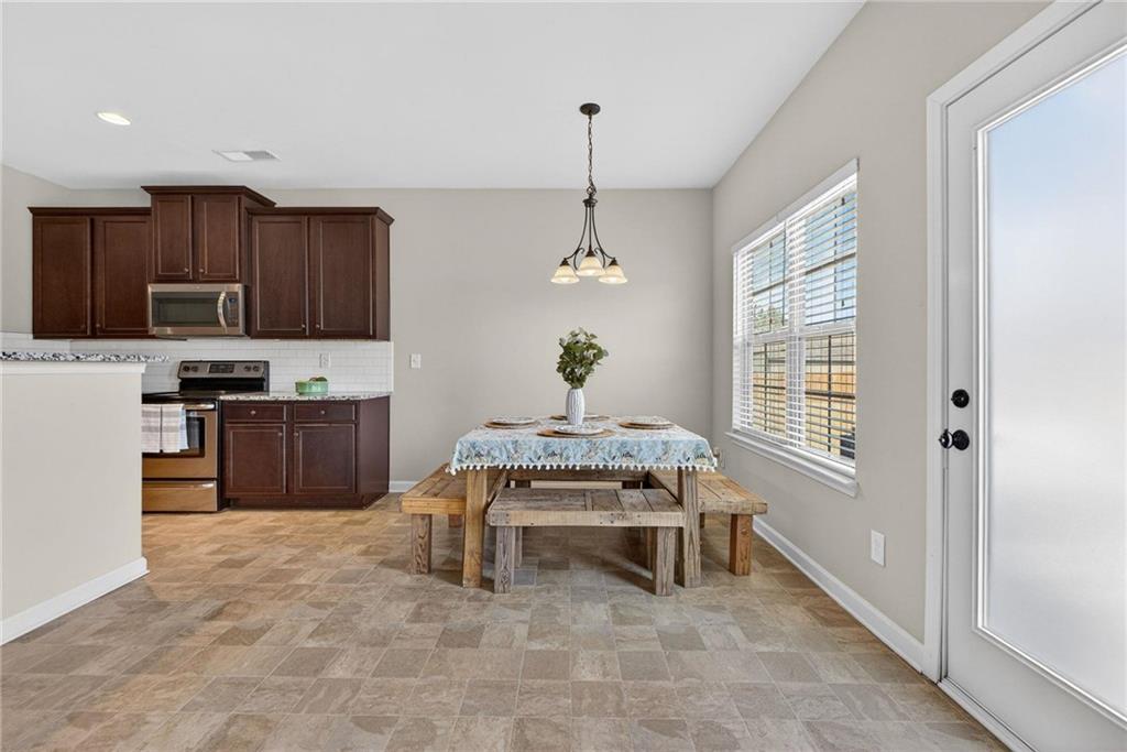 214 Millie Court Jackson, GA 30233 - Photo 24 of 61 a living room with furniture a window and kitchen appliances