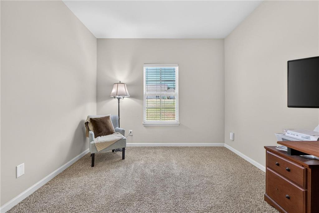 214 Millie Court Jackson, GA 30233 - Photo 25 of 61 a living room with furniture and a chair