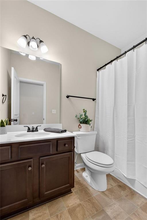 214 Millie Court Jackson, GA 30233 - Photo 28 of 61 a bathroom with a toilet a sink and mirror