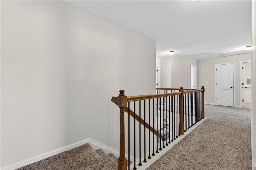 214 Millie Court Jackson, GA 30233 - Photo 29 of 61 a view of a hallway with wooden floor and windows