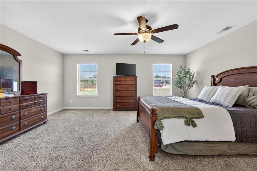 214 Millie Court Jackson, GA 30233 - Photo 30 of 61 a bedroom with a bed and a dresser