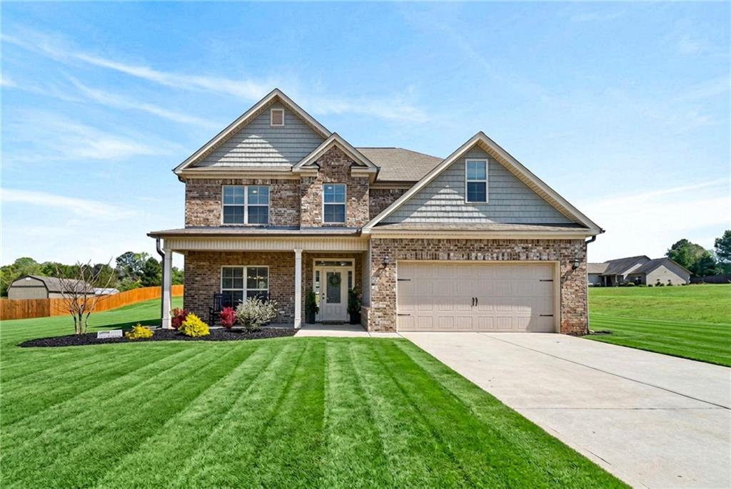 214 Millie Court Jackson, GA 30233 - Photo 3 of 61 a front view of house with yard and green space