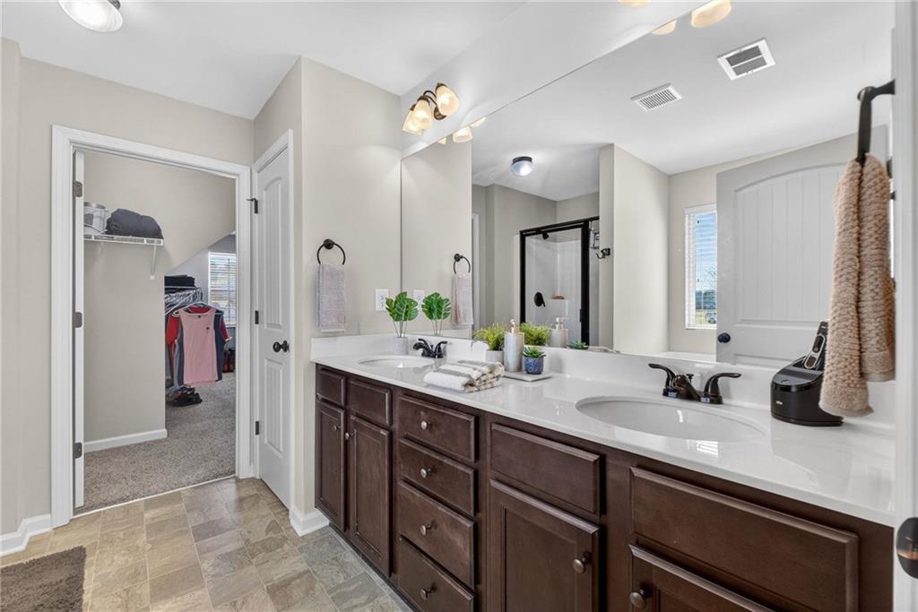 214 Millie Court Jackson, GA 30233 - Photo 33 of 61 a spacious bathroom with a double vanity sink double and mirror