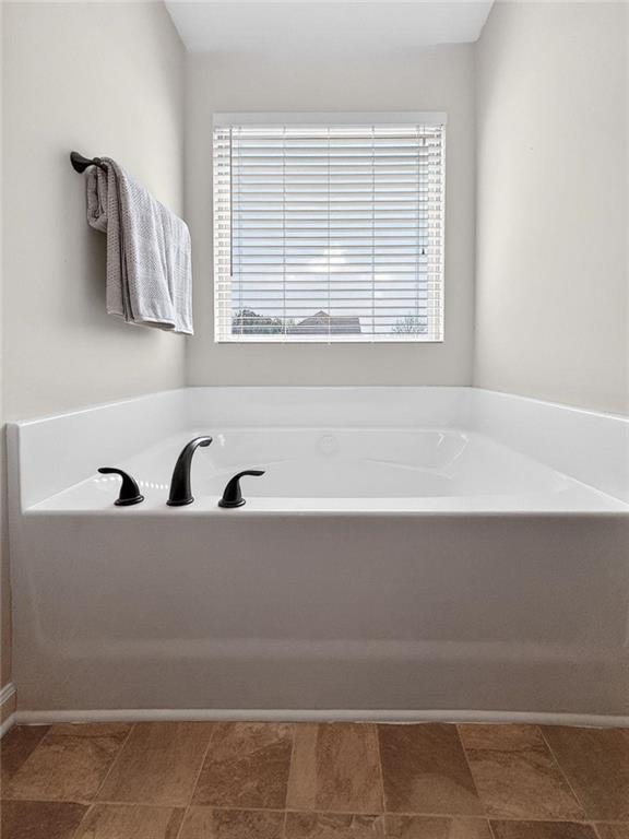 214 Millie Court Jackson, GA 30233 - Photo 34 of 61 a bathroom with a bathtub and a window