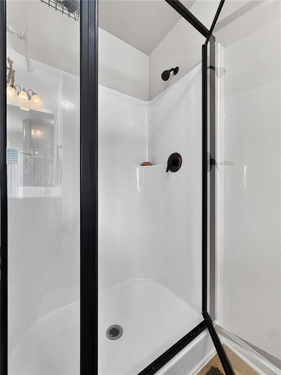 214 Millie Court Jackson, GA 30233 - Photo 35 of 61 a bathroom with a glass shower door