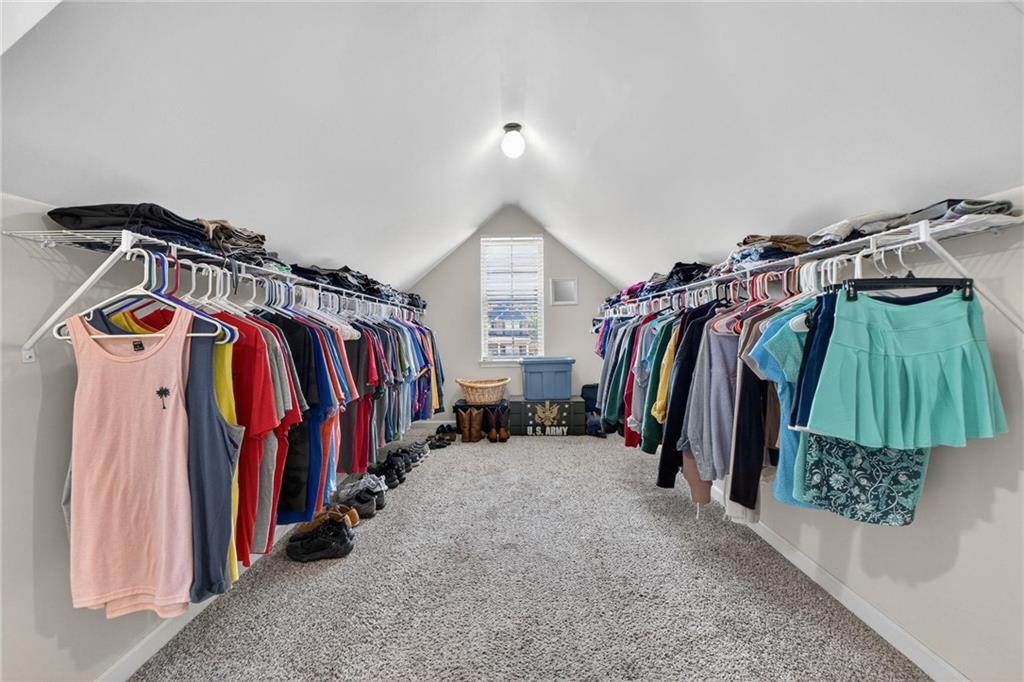 214 Millie Court Jackson, GA 30233 - Photo 36 of 61 a view of walk in closet with clothes and shoes