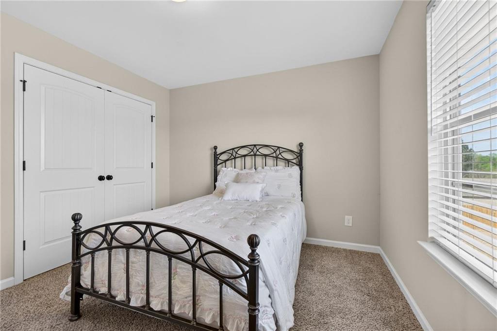 214 Millie Court Jackson, GA 30233 - Photo 42 of 61 a bedroom with a bed and a window