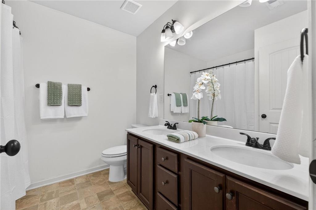 214 Millie Court Jackson, GA 30233 - Photo 43 of 61 a bathroom with a double vanity sink mirror and toilet