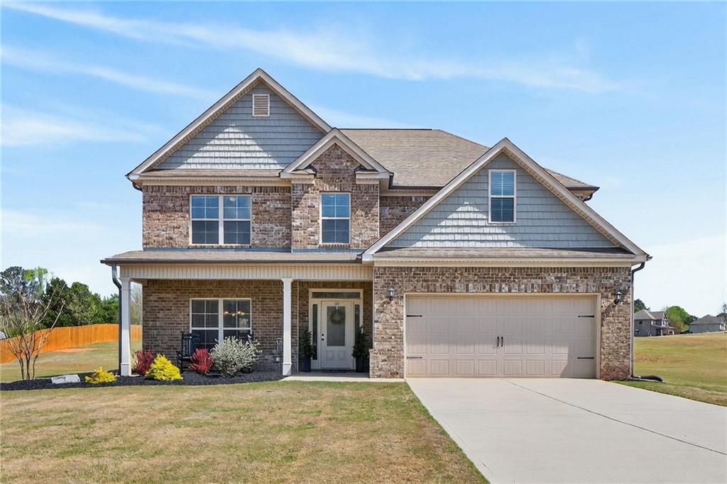 214 Millie Court Jackson, GA 30233 - Photo 55 of 61 a front view of a house with a yard and balcony