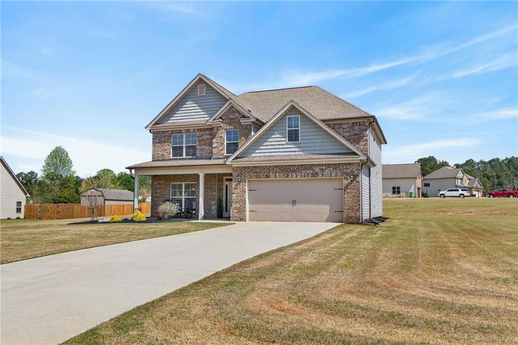 214 Millie Court Jackson, GA 30233 - Photo 56 of 61 a front view of a house with a yard and garage