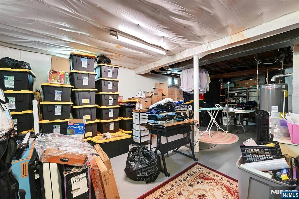 85 Edison Street Clifton, NJ 07013 - Photo 23 of 28 a room with lots of furniture and clutter