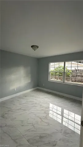 a view of an empty room and a window