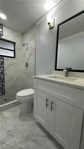 a bathroom with a toilet sink and shower