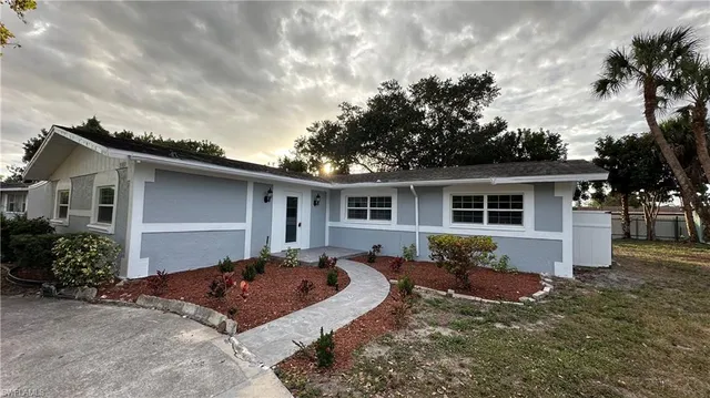 a front view of house with yard outdoor seating and barbeque oven