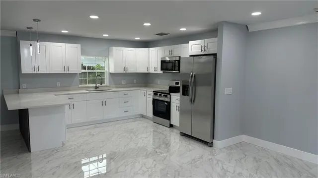 a kitchen with a sink stainless steel appliances and cabinets