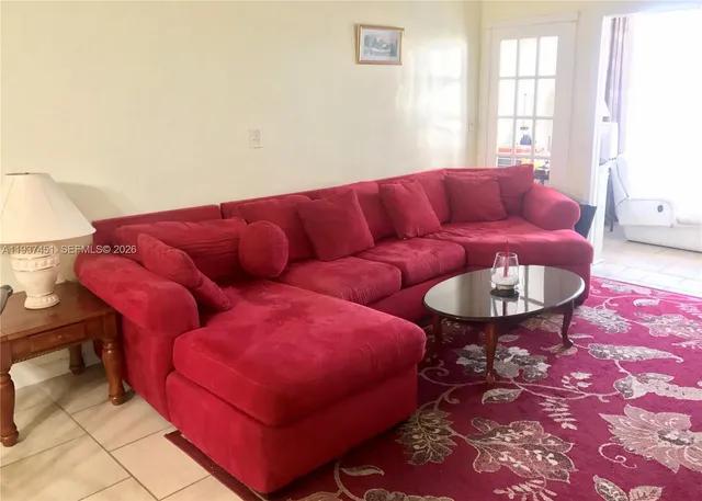 a living room with furniture and a rug