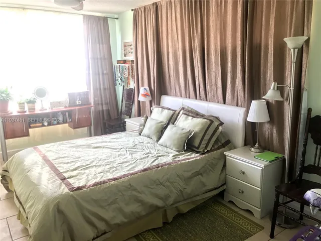 a bedroom with a bed and a mirror