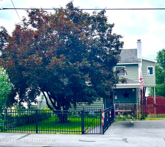 front view of a house with a garden