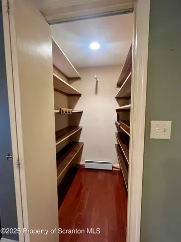 a view of walk in closet with empty racks