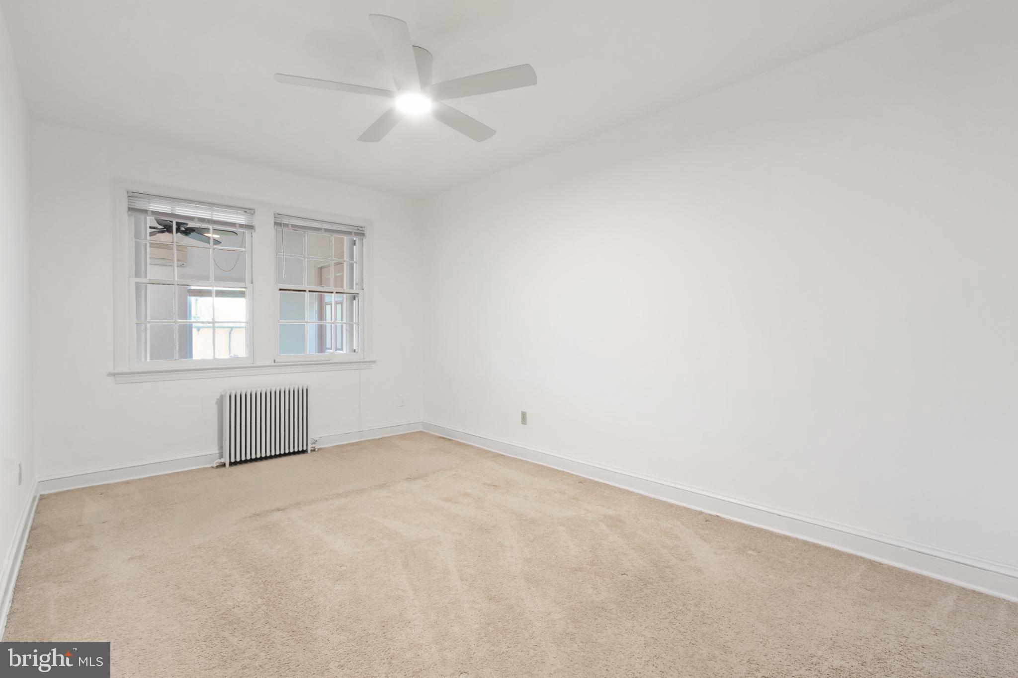 4500 MacArthur Boulevard Northwest Washington, DC 20007 - Photo 14 of 16 an empty room with windows and ceiling fan