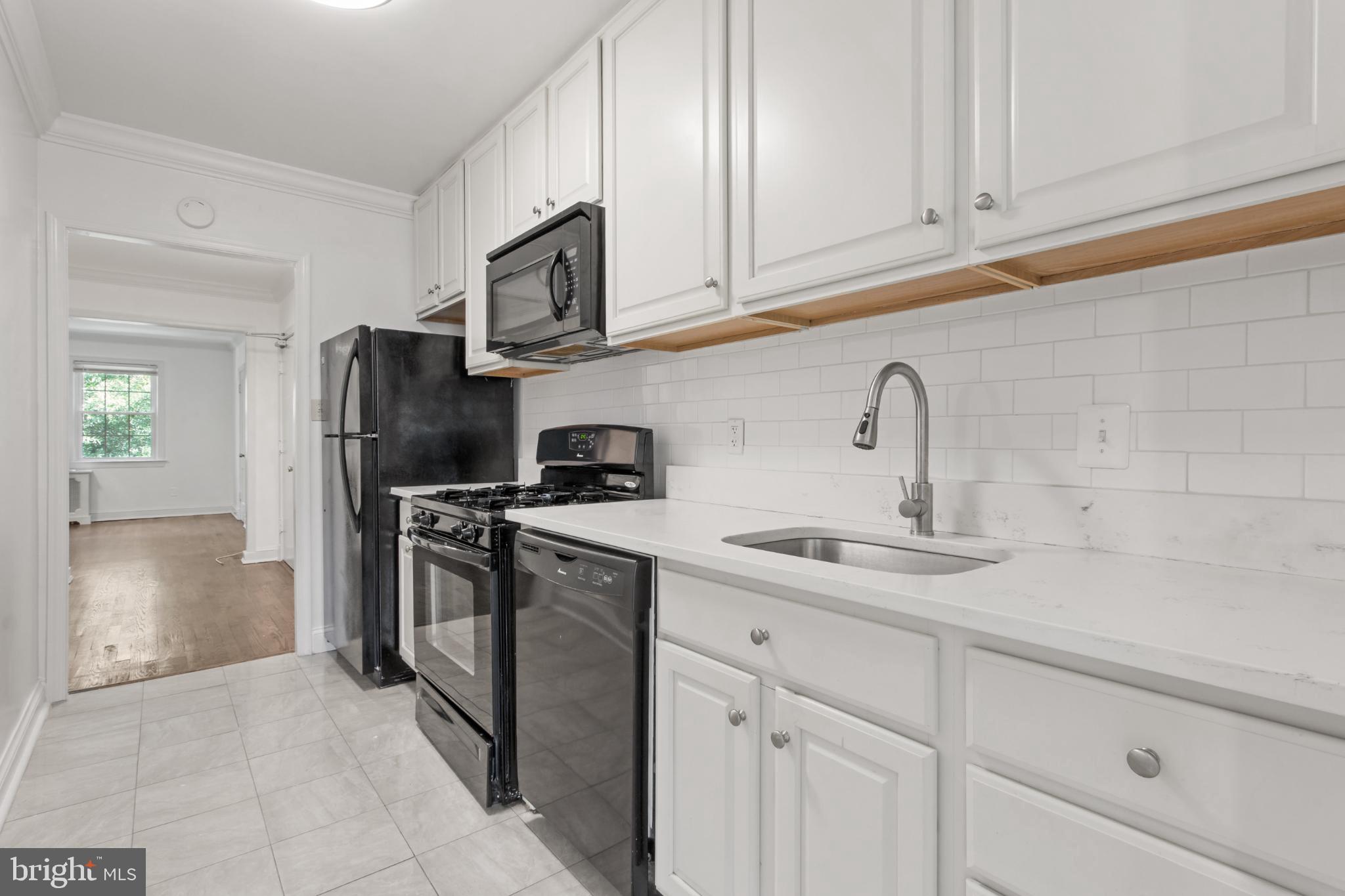 4500 MacArthur Boulevard Northwest Washington, DC 20007 - Photo 15 of 16 a kitchen with stainless steel appliances granite countertop a refrigerator sink and stove