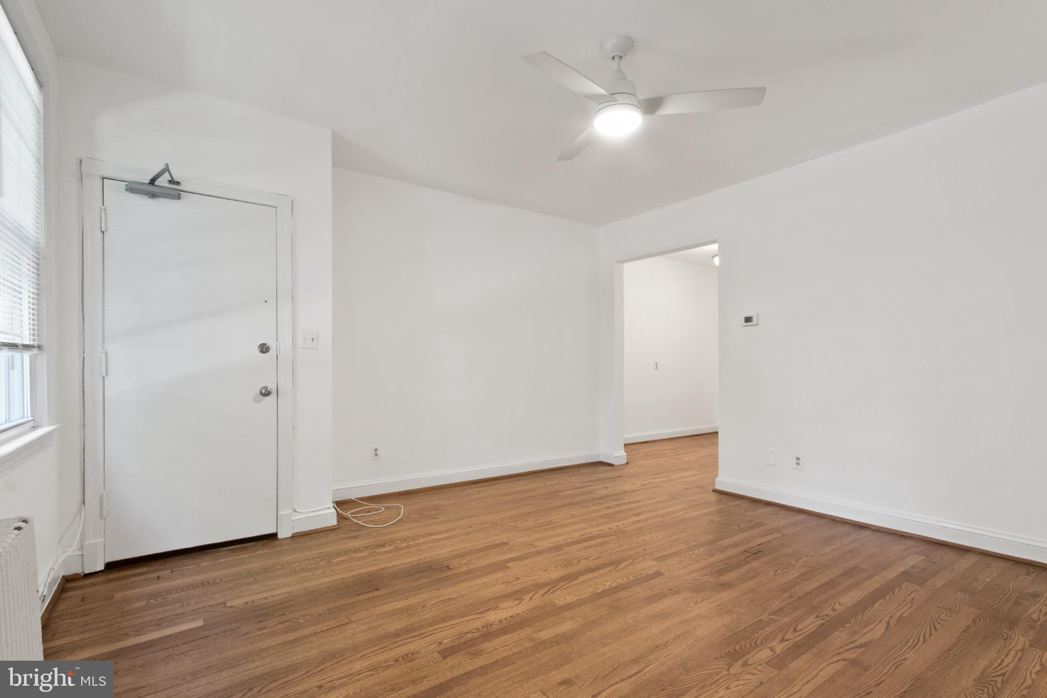 4500 MacArthur Boulevard Northwest Washington, DC 20007 - Photo 9 of 16 an empty room with wooden floor and a ceiling fan