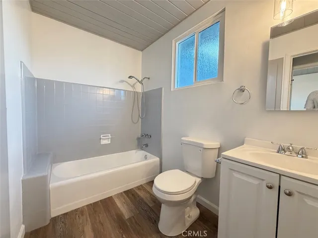 a bathroom with a toilet a sink and bathtub