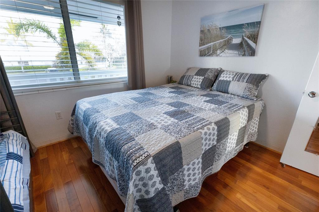 750 Pine Drive, Unit 11 Pompano Beach, FL 33060 - Photo 14 of 22 a bed sitting in a bedroom next to a window