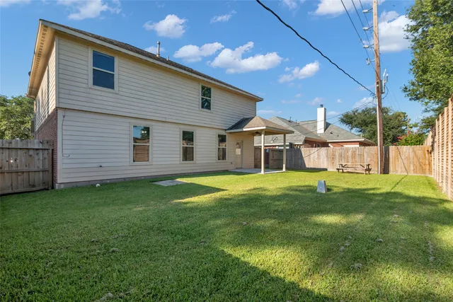 a view of a house with a backyard