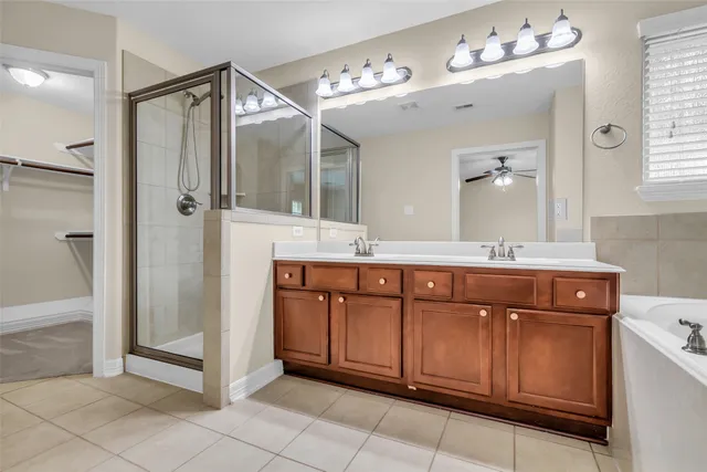 a spacious bathroom with a granite countertop sink mirror and