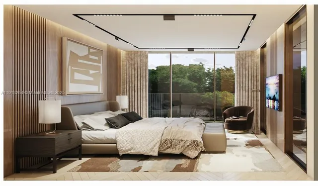 a large bedroom with a bed and wooden floor