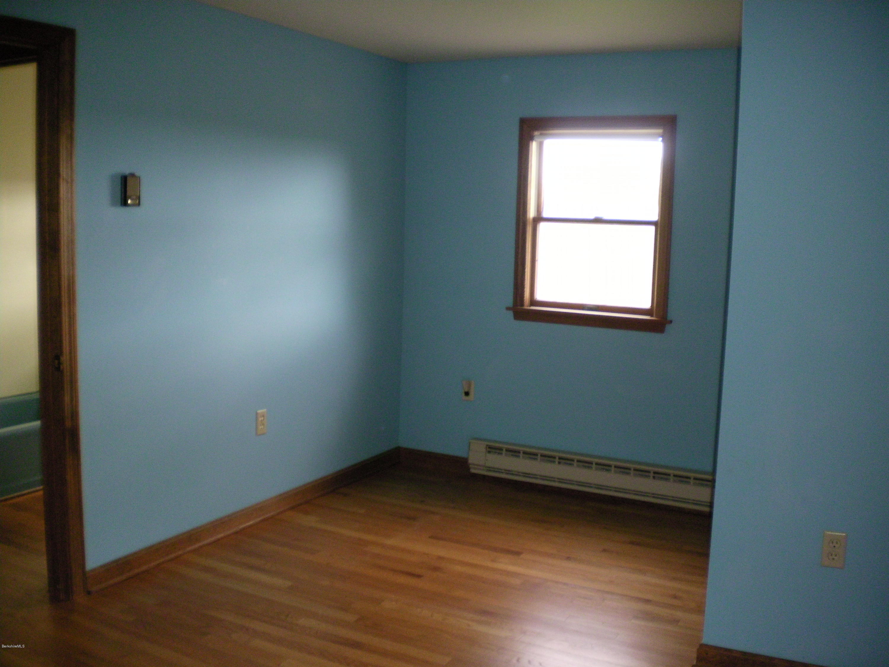 7 Pierce Road Peru, MA 01235 - Photo 26 of 29 an empty room with wooden floor and windows