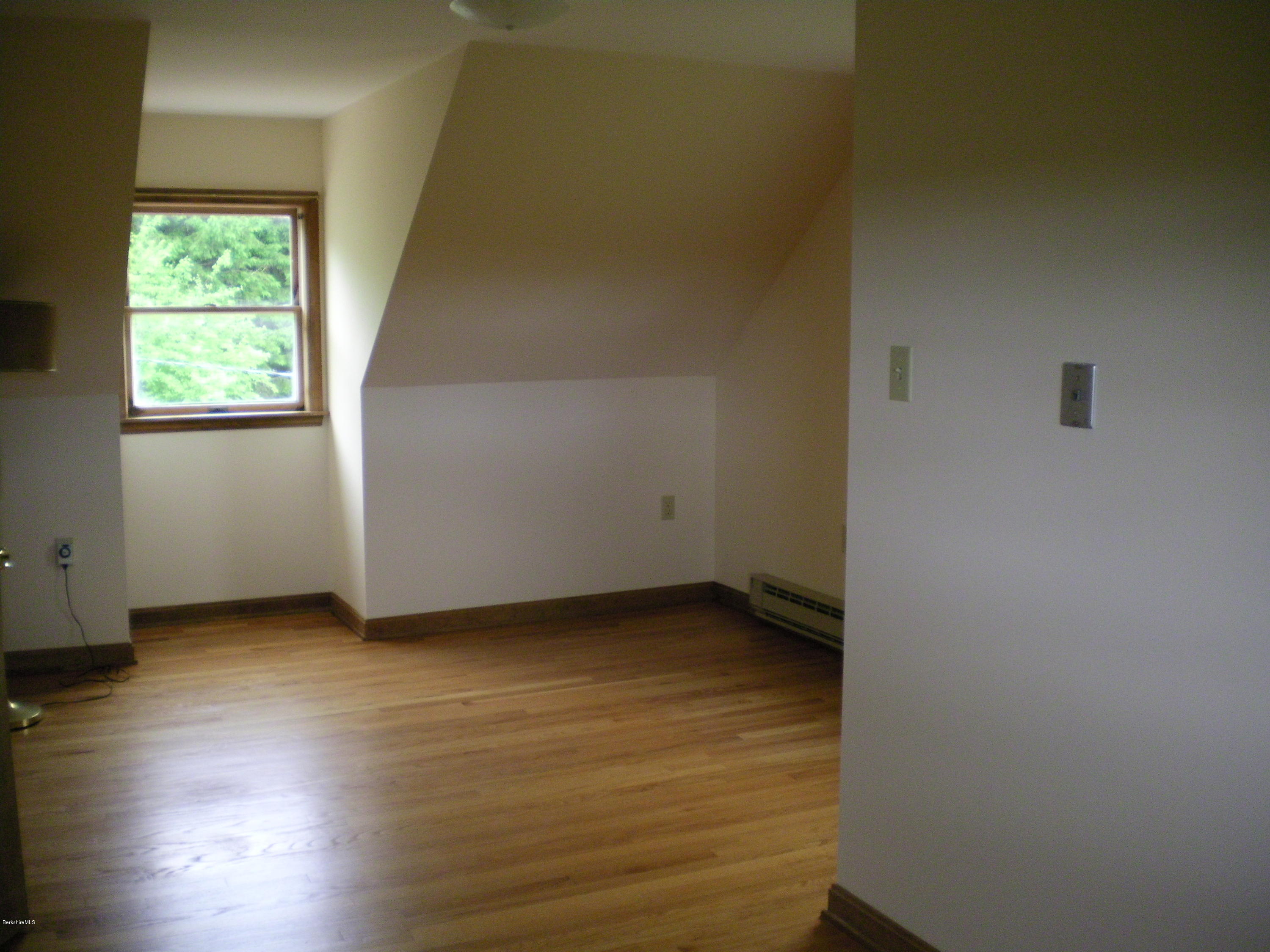 7 Pierce Road Peru, MA 01235 - Photo 28 of 29 an empty room with wooden floor and windows