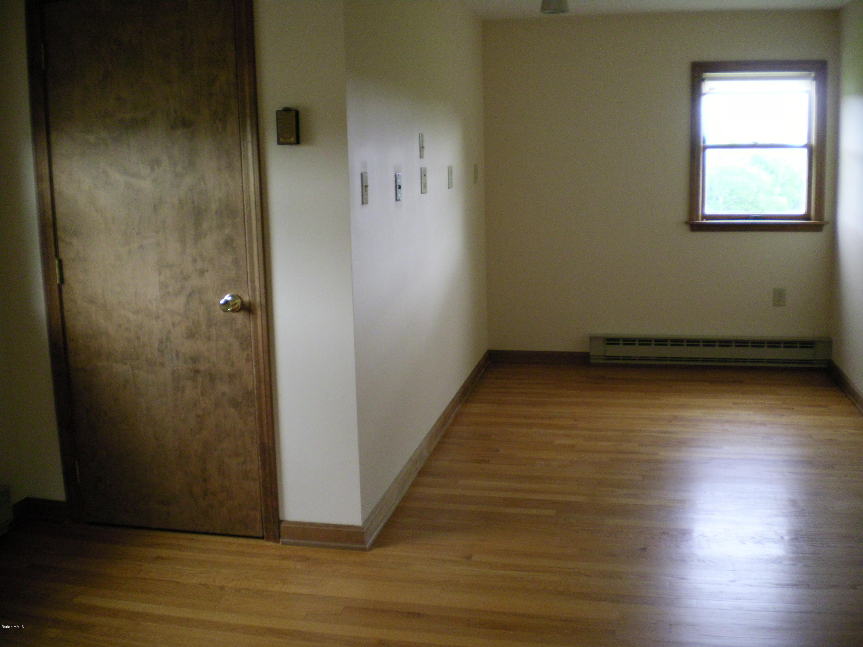 7 Pierce Road Peru, MA 01235 - Photo 29 of 29 an empty room with wooden floor and windows