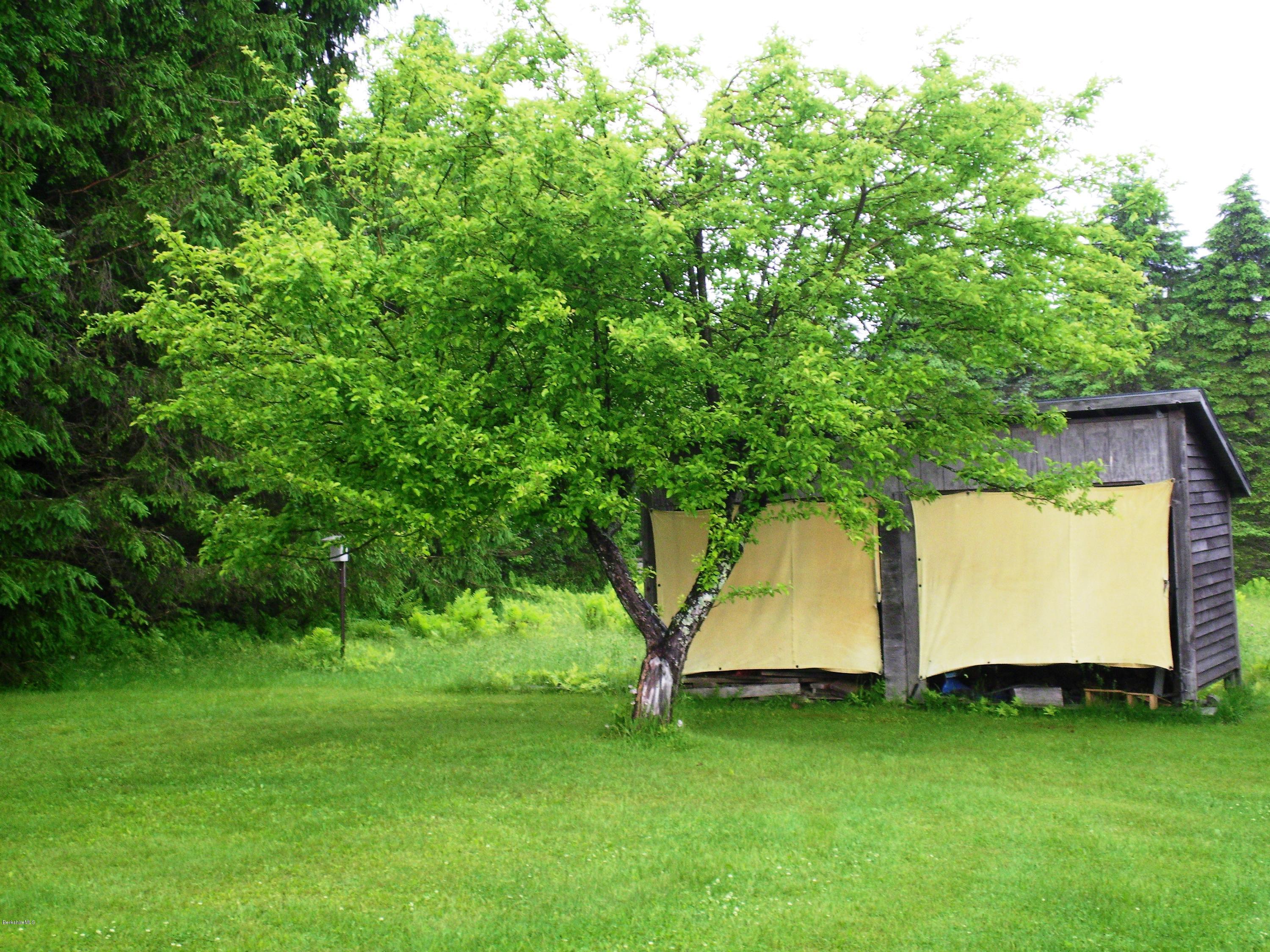 7 Pierce Road Peru, MA 01235 - Photo 8 of 29 a view of a white house with a big yard and large trees