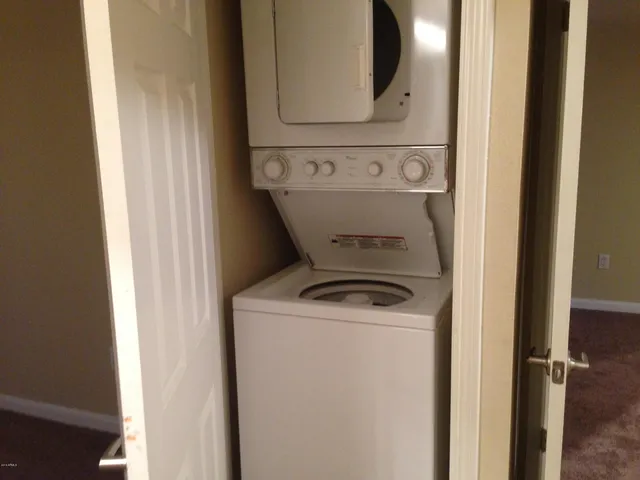 a view of a swimming pool with a garden and patio