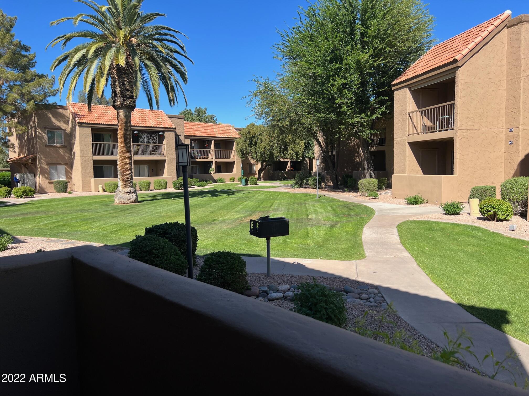 8256 East Arabian Trail, Unit 132 Scottsdale, AZ 85258 - Photo 16 of 19 a view of a swimming pool with a garden and patio