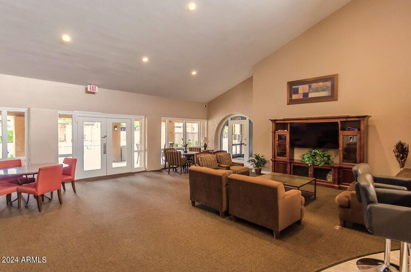 8256 East Arabian Trail, Unit 132 Scottsdale, AZ 85258 - Photo 17 of 19 a living room with furniture fireplace and large windows