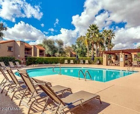 8256 East Arabian Trail, Unit 132 Scottsdale, AZ 85258 - Photo 19 of 19 a view of swimming pool with outdoor seating and barbeque oven