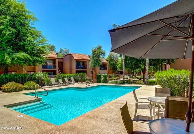 a view of a house with backyard porch and sitting area