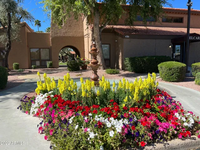 a front view of a house with a yard and fountain