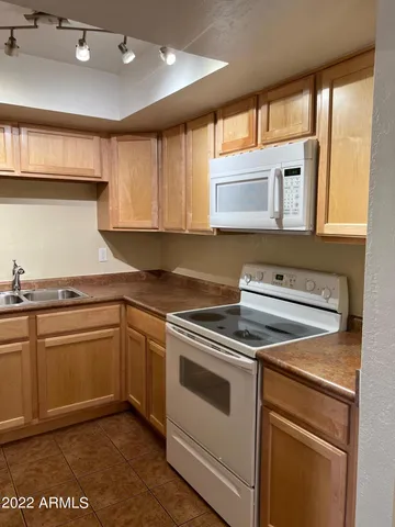 a kitchen with a refrigerator and a sink