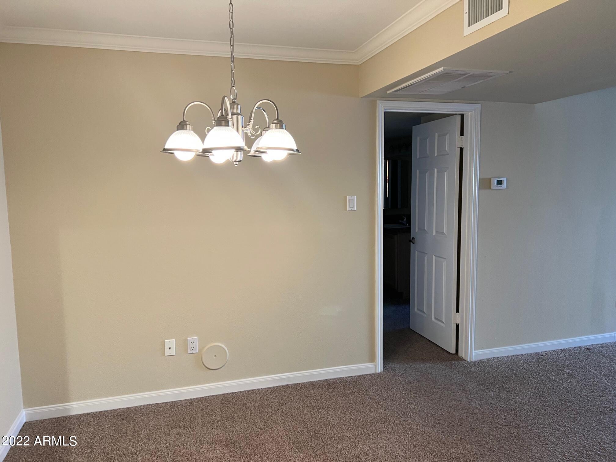 8256 East Arabian Trail, Unit 132 Scottsdale, AZ 85258 - Photo 8 of 19 a view of a dining room with a chandelier fan and a refrigerator