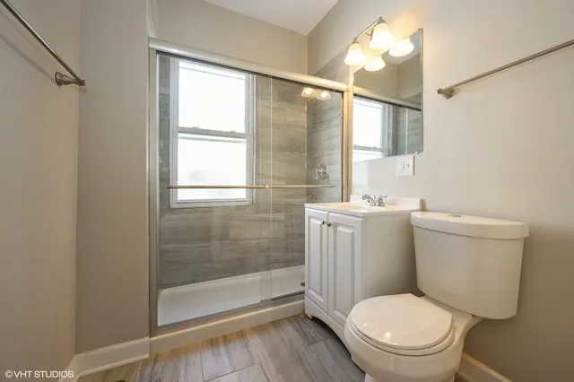 a white toilet sitting next to a bathroom sink