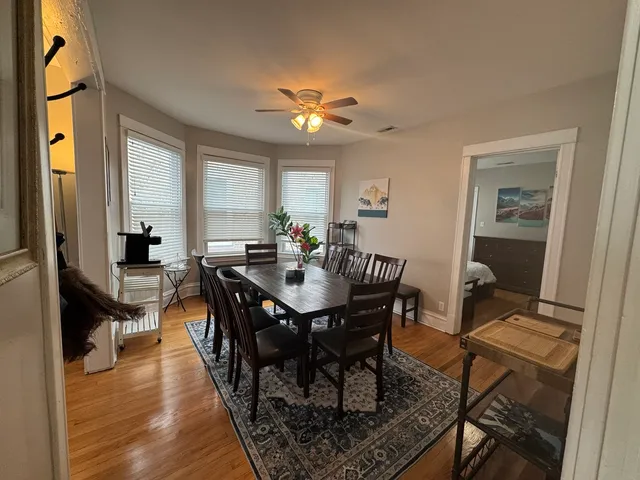 a view of a a dining room with furniture window and wooden floor