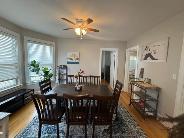 a view of a dining room with furniture and chandelier